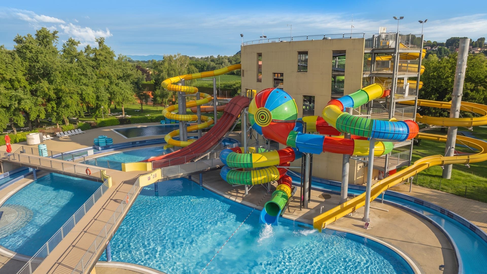 The waterslides at Terme Ptuj, their coloured tubes curving above the outdoor pools.