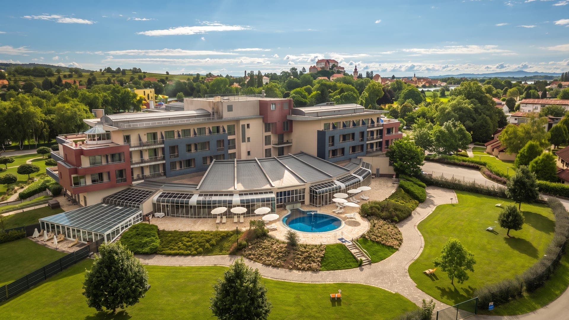 Aerial view of the hotel with its glass-domed pool wing and gardens