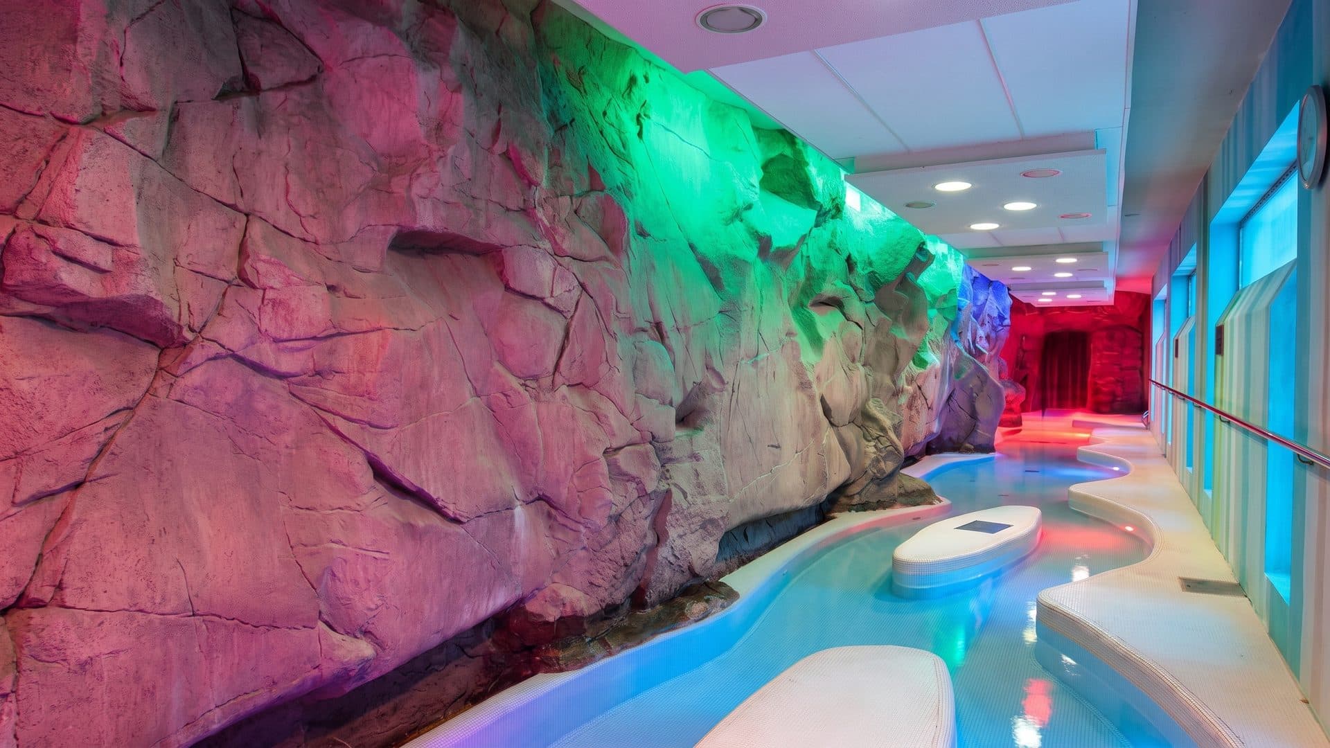 The grotto pool of Terme San Luca with its rockwork under coloured light