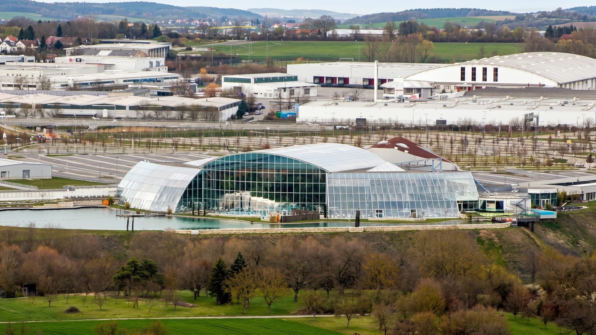 The glass dome beside its lake, seen across the valley