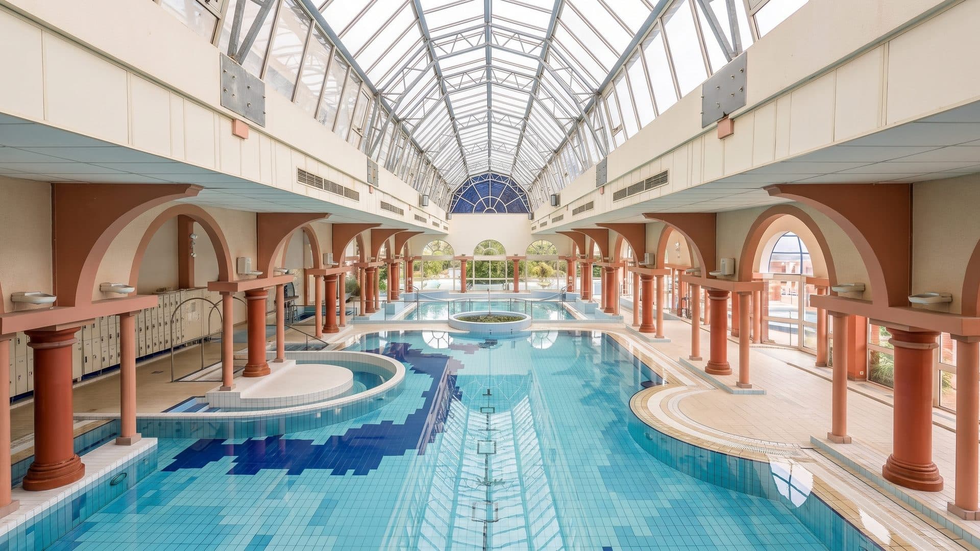 The belle-epoque hall of the Thermes Borda seen from the gallery above its pool