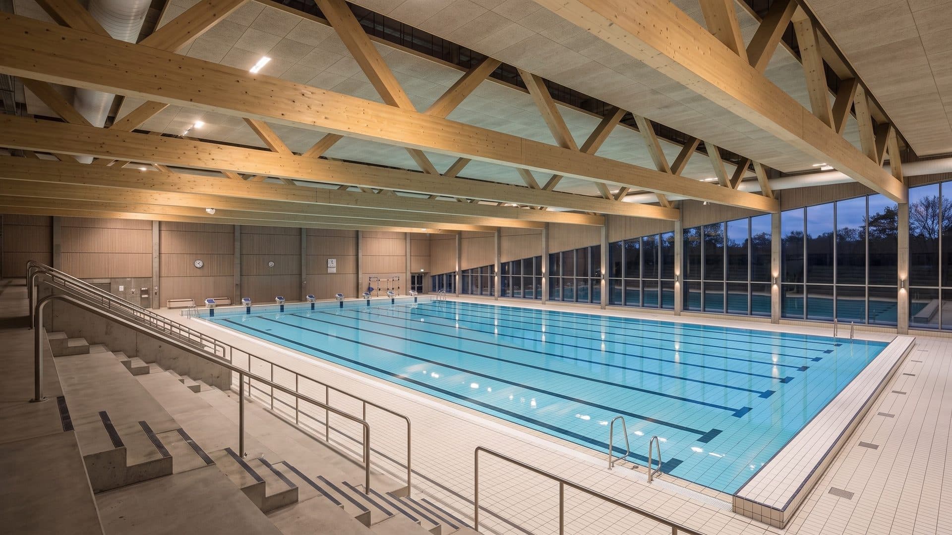 The competition pool of Tinnerbacksbadet in Linkoping under a laminated timber roof, stands alongside