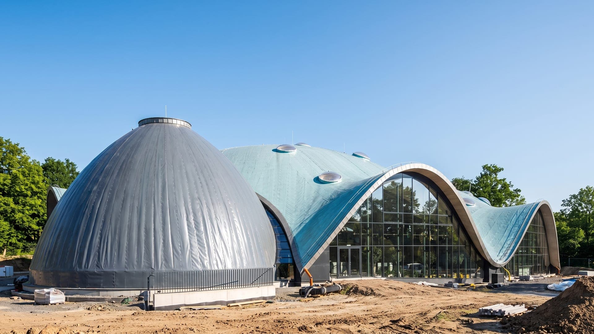 Curved shell roofs of the bath among trees