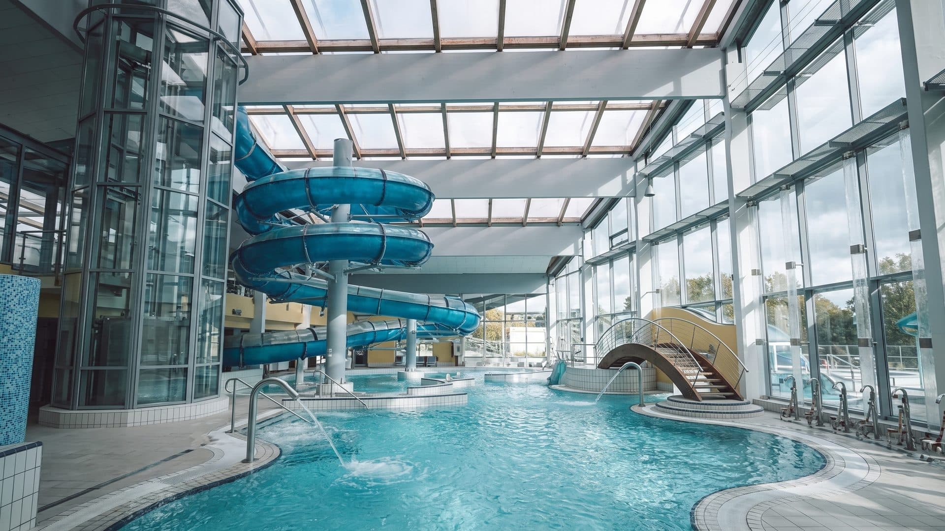 The hall of Triamare with its slide tower above the pools under a glazed roof