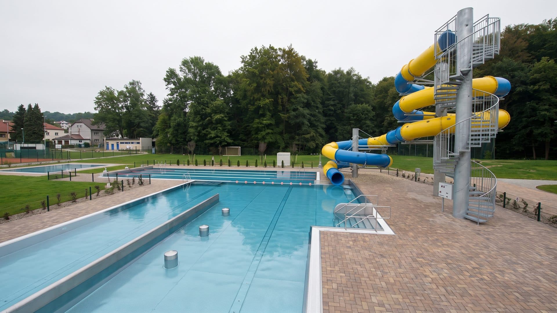 The outdoor pools of the Trzebnica water park with its slide tower and lawns