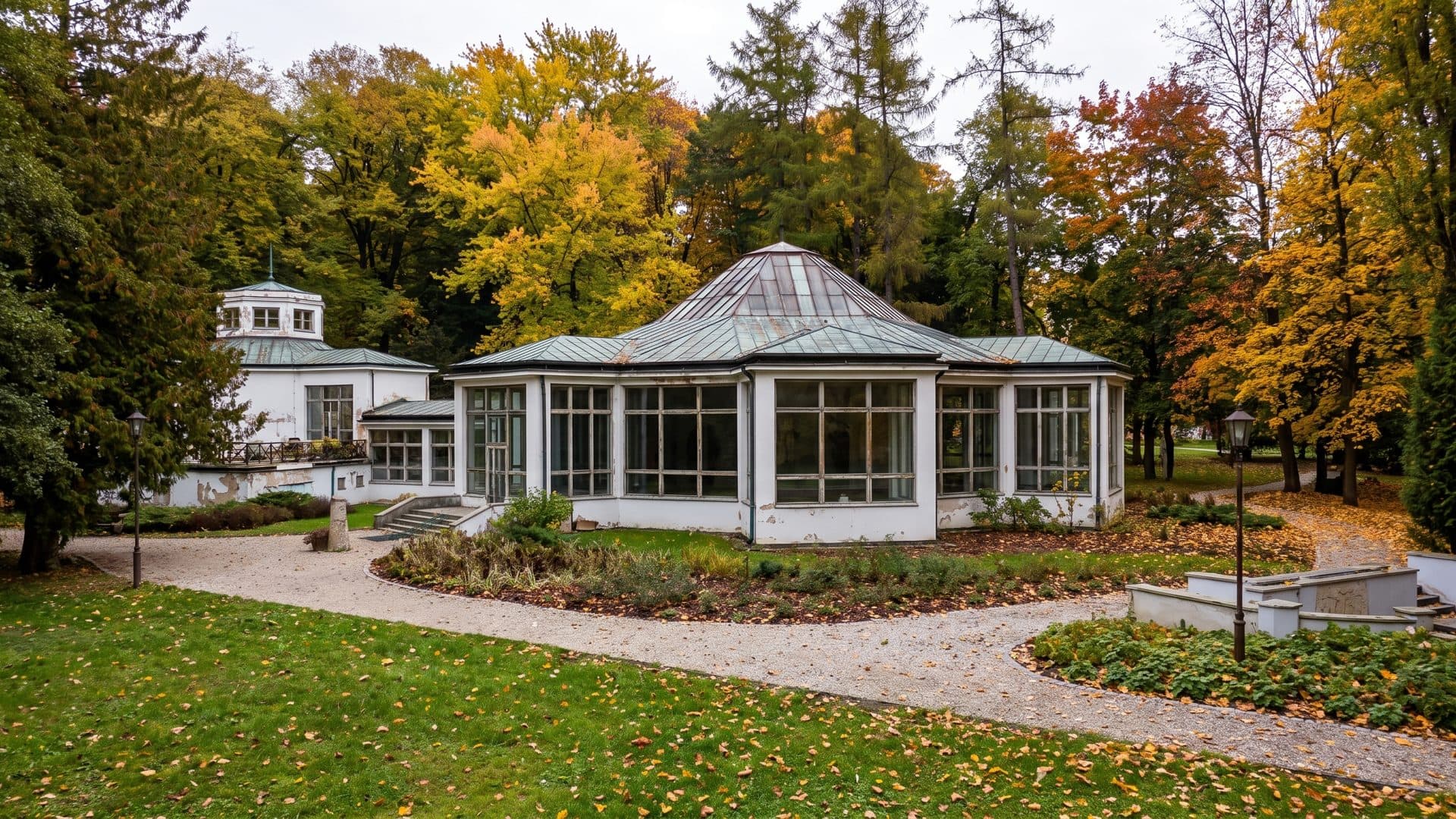 The glazed park pavilion of the Naleczow spa among autumn trees.