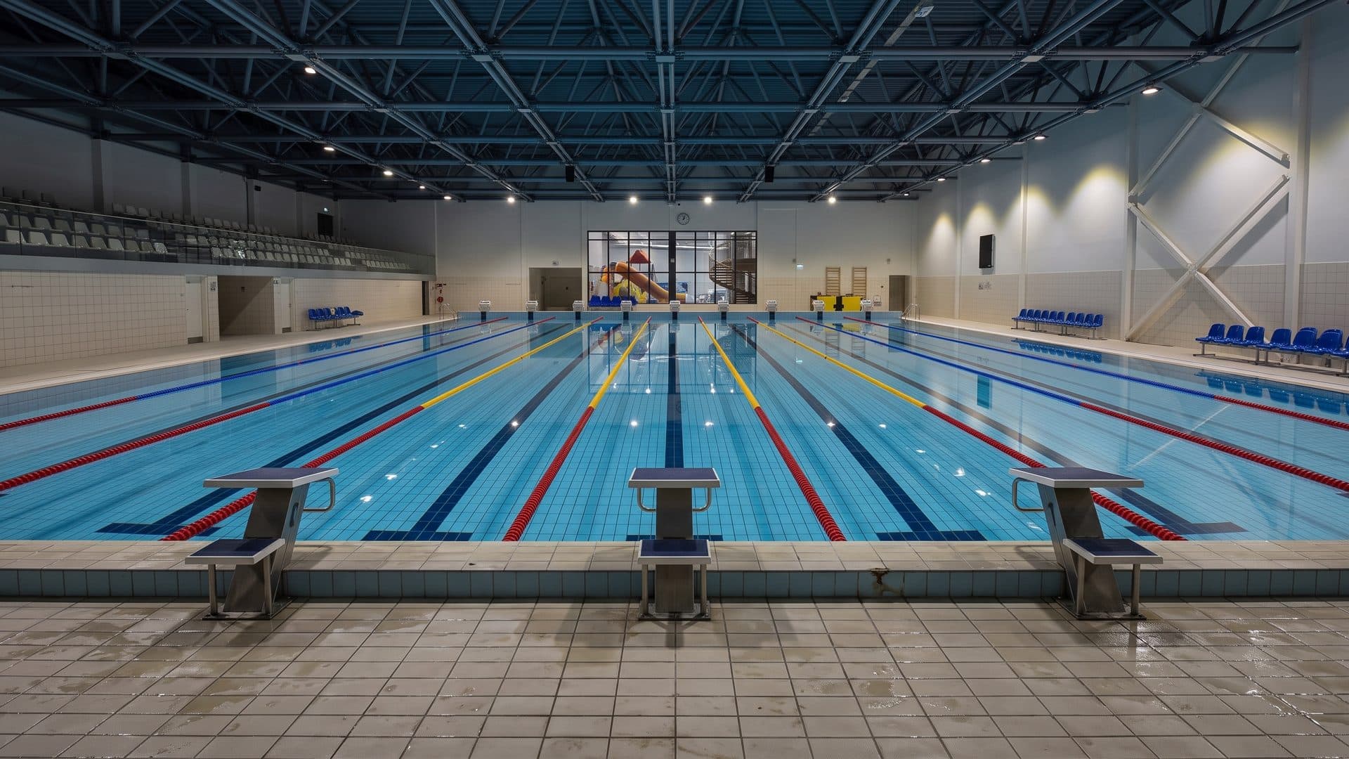 The lane pool of the Valmiera swimming centre with starting blocks and spectator stands