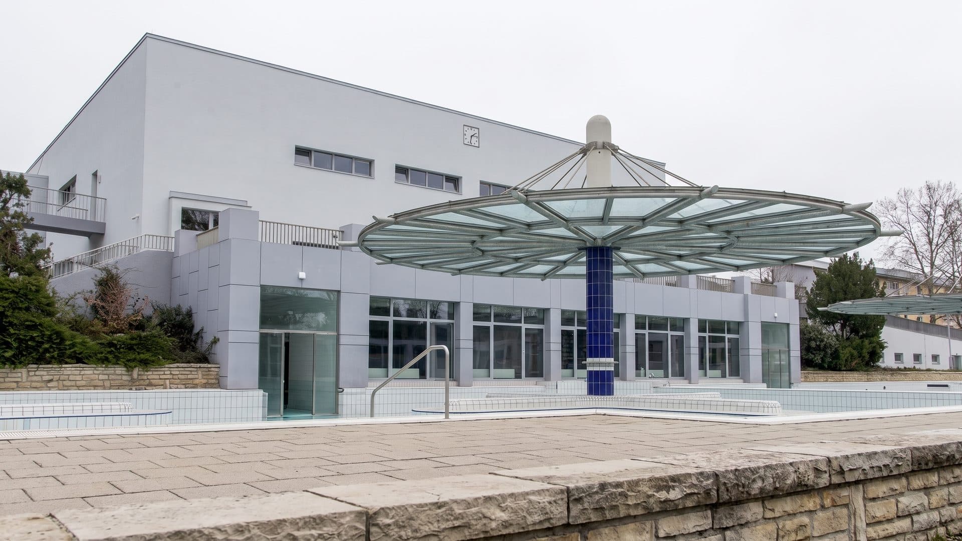 The front of the municipal baths with its canopy over the paved forecourt