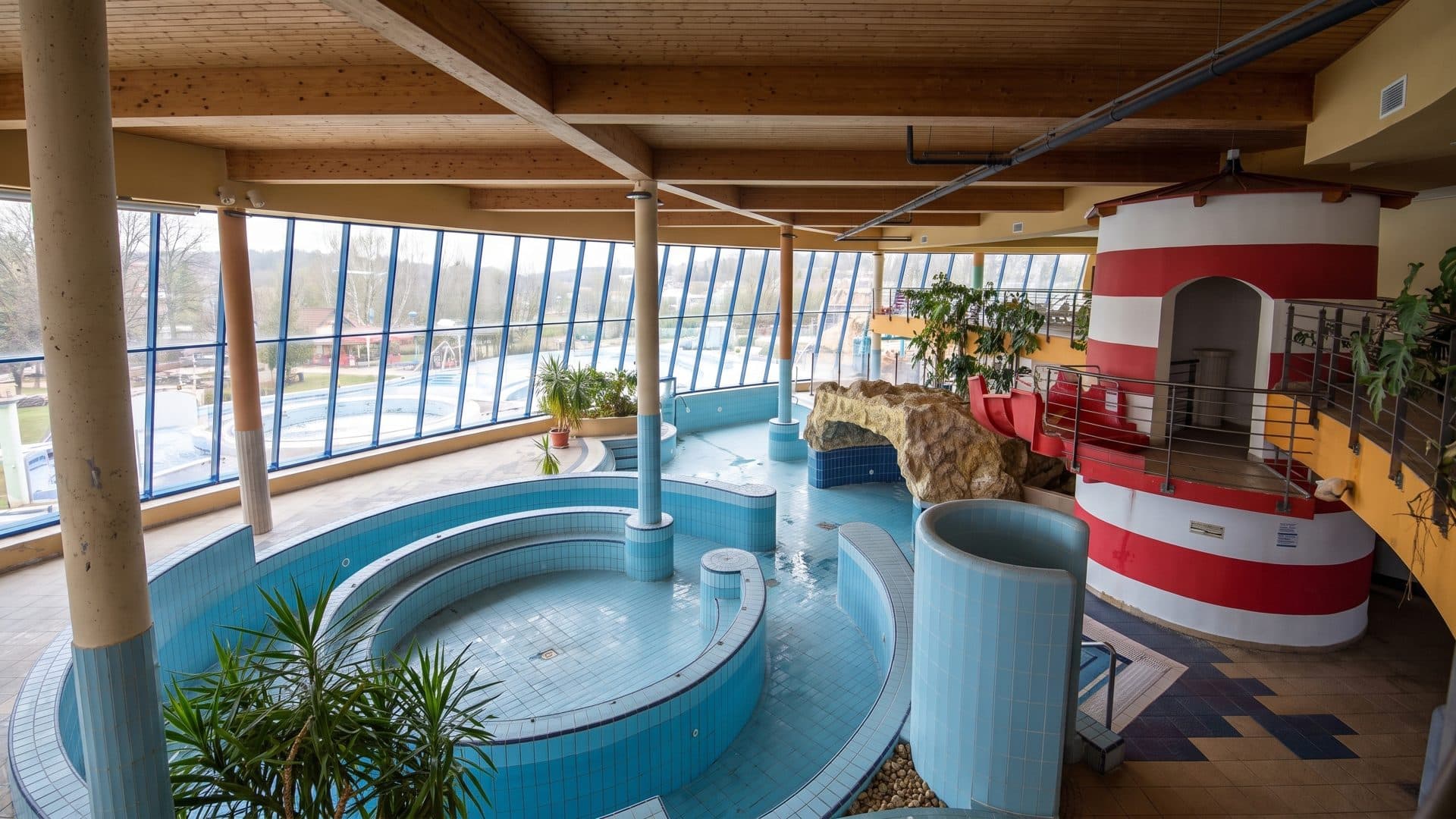 The pool hall of the Viragfurdo with its lighthouse-shaped slide tower