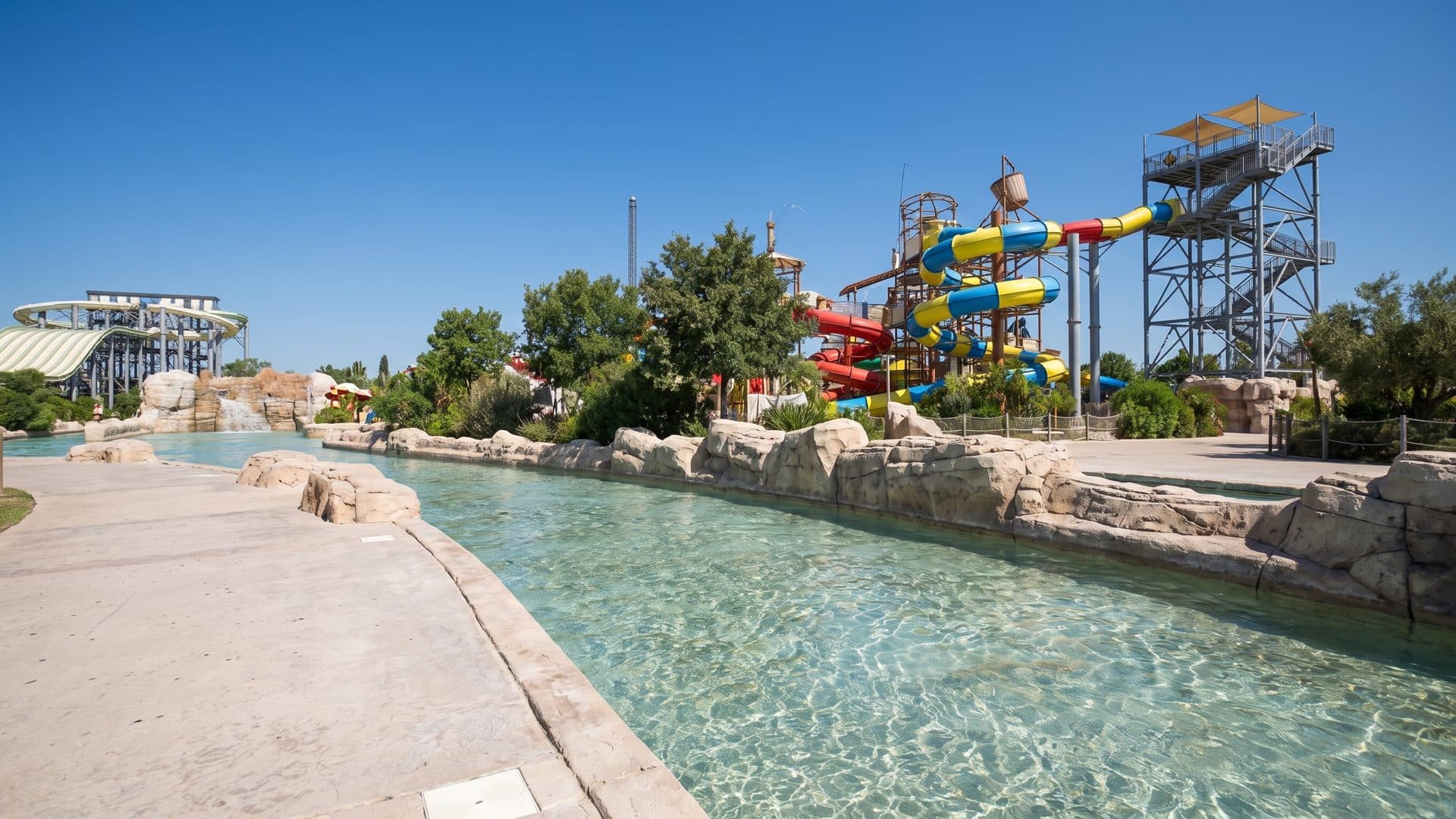 The lazy river of Wave Island running between its rock banks below the slide towers