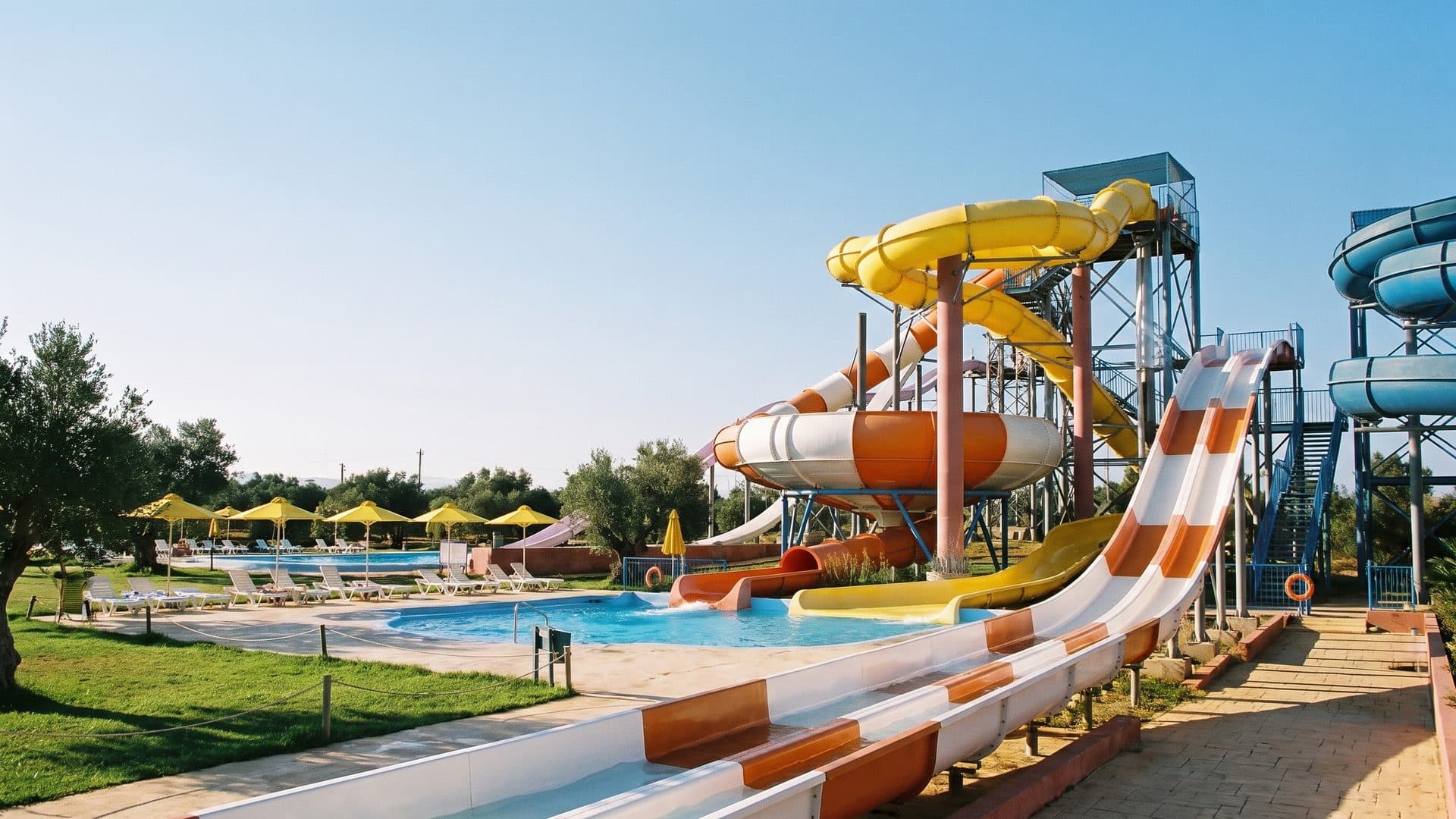 Zante Water Village with its yellow slide tower above the pools and parasols