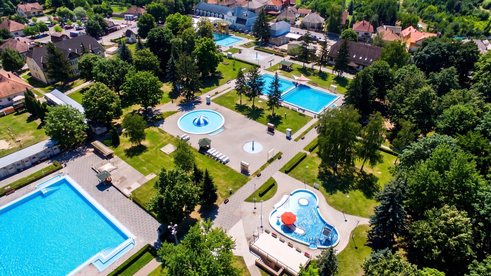 The thermal bath at Bogacs seen from the air, its pools and lawns among trees at the edge of the village.